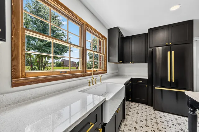a kitchen with a refrigerator and window