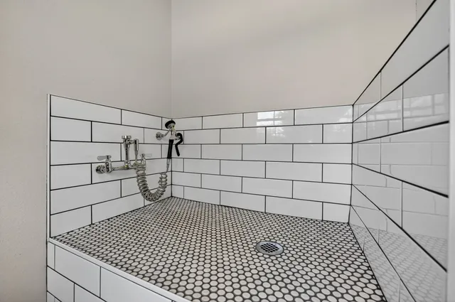 a bathroom with a granite countertop toilet sink and mirror