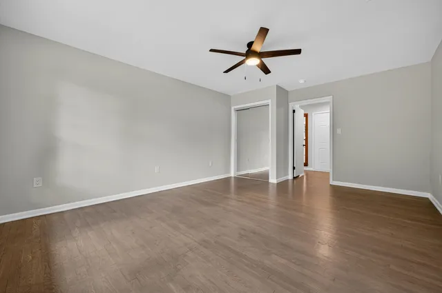 a view of a livingroom with a ceiling fan and window