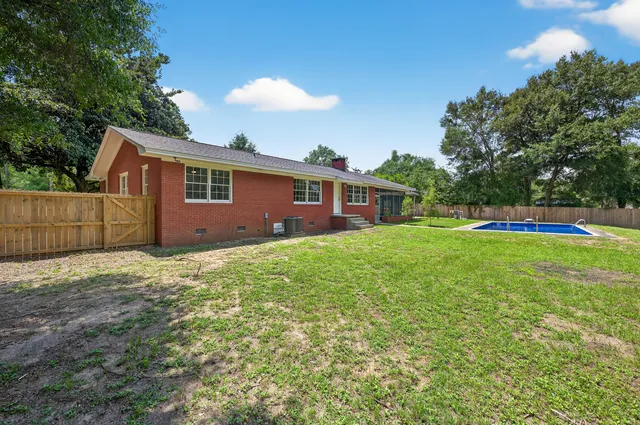 a view of swimming pool with a yard