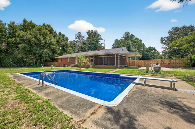 a view of a swimming pool with a yard and mountain