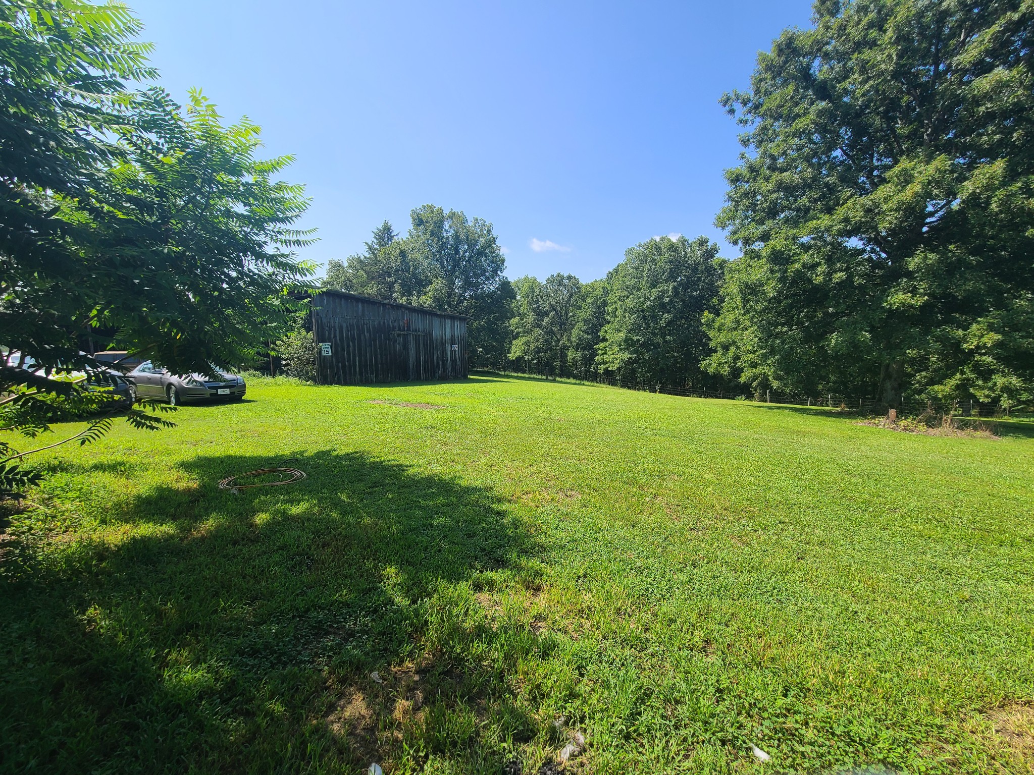 954 South Buchanan Road Waverly, TN 37185 - Photo 20 of 20 a view of a grassy field with trees in the background