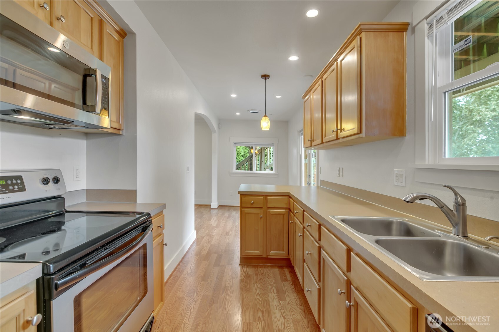 4945 North Pearl Street Ruston, WA 98407 - Photo 11 of 22 a kitchen with stainless steel appliances granite countertop a sink and a stove