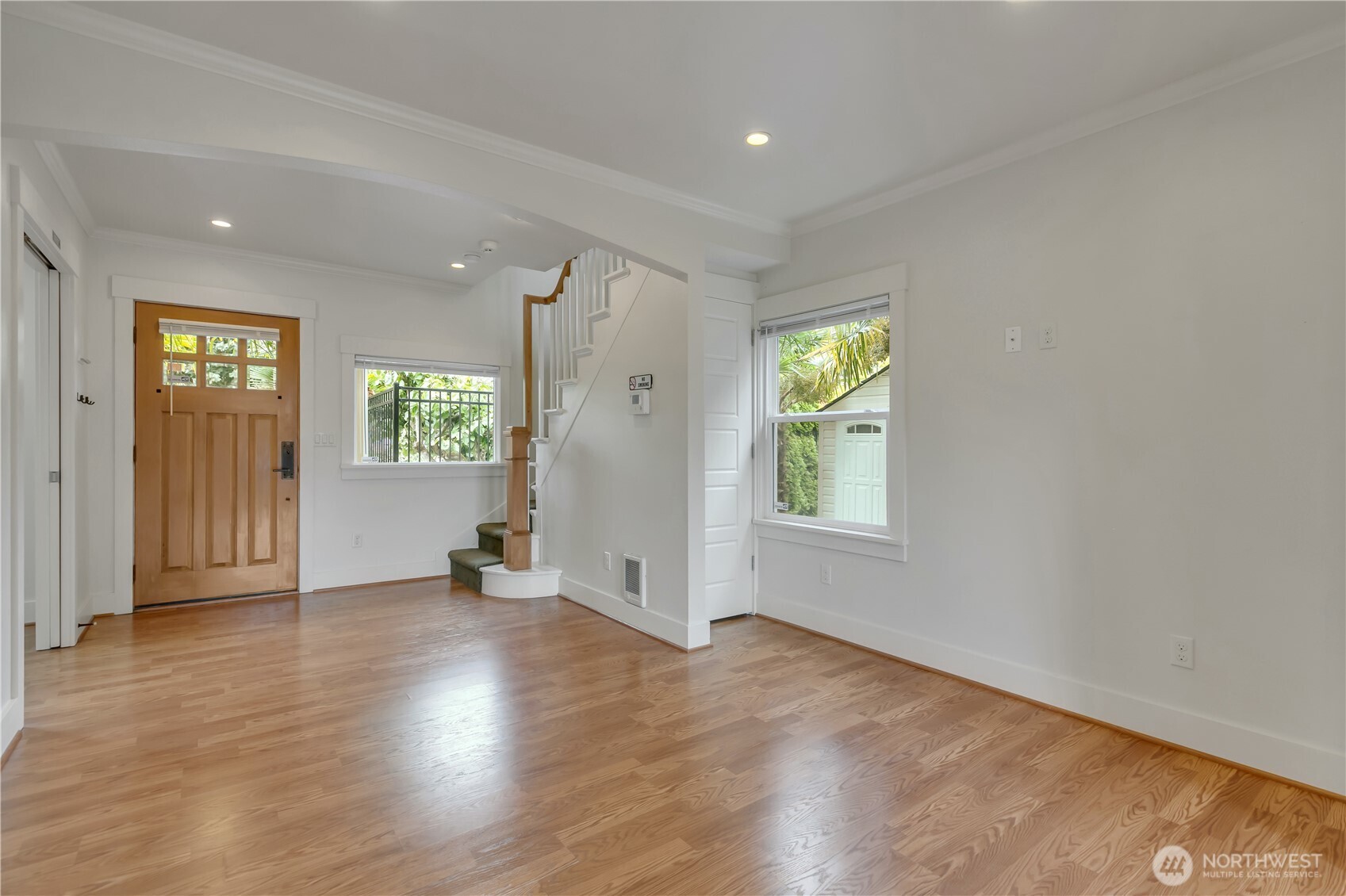 4945 North Pearl Street Ruston, WA 98407 - Photo 6 of 22 an empty room with wooden floor and windows