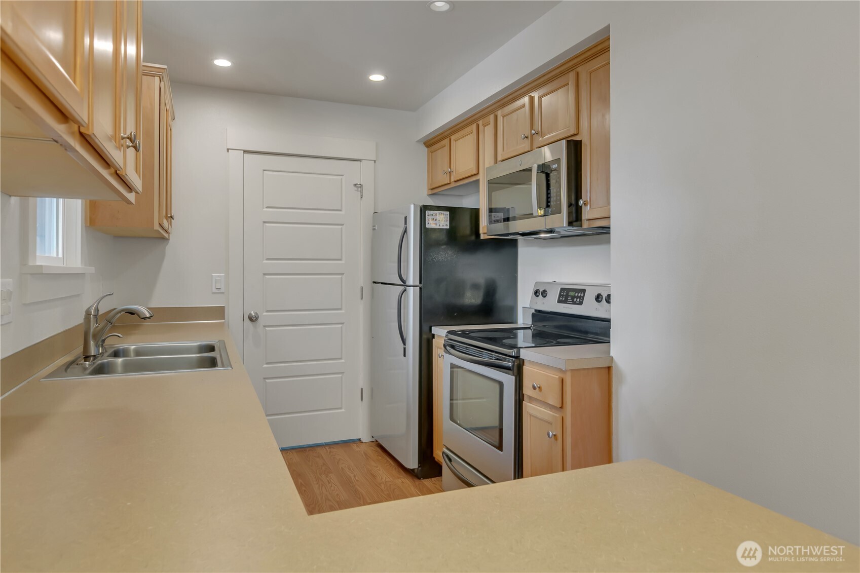 4945 North Pearl Street Ruston, WA 98407 - Photo 10 of 22 a kitchen with stainless steel appliances granite countertop a refrigerator and a stove top oven