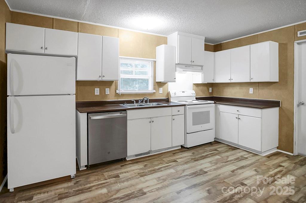 203 Bethlehem Church Road Grover, NC 28073 - Photo 11 of 34 a kitchen with cabinets appliances a sink and a window