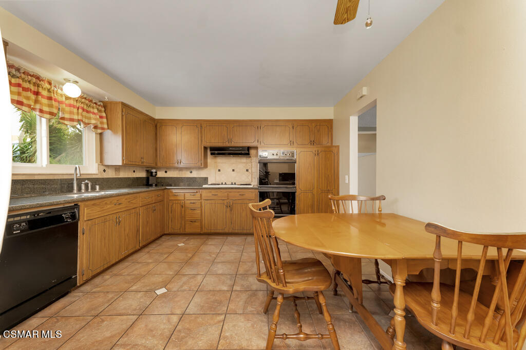 1300 Rachel Drive Oxnard, CA 93030 - Photo 11 of 50 a kitchen with a sink chairs and wooden floor