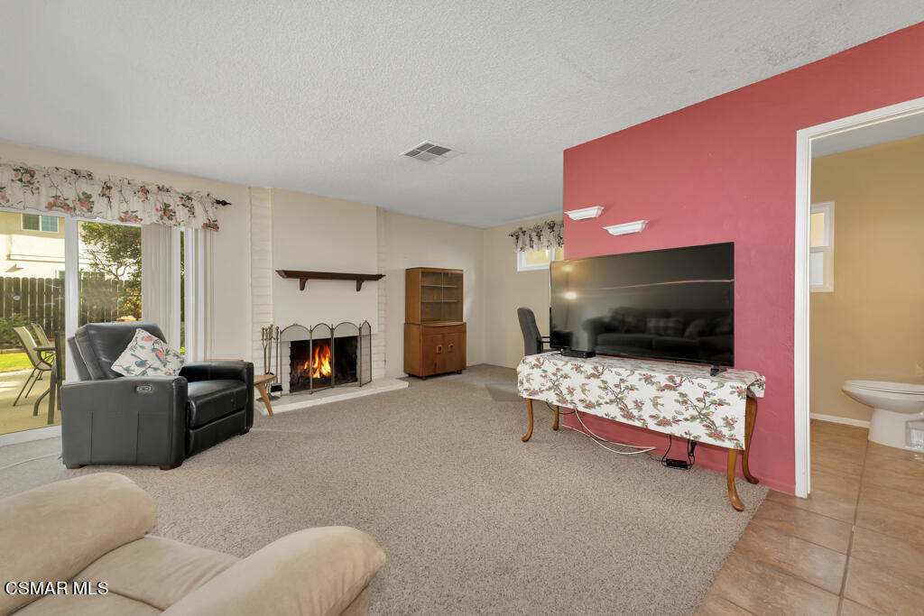 1300 Rachel Drive Oxnard, CA 93030 - Photo 16 of 50 a living room with furniture a flat screen tv and a fireplace