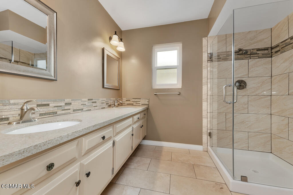 1300 Rachel Drive Oxnard, CA 93030 - Photo 21 of 50 a bathroom with a granite countertop sink a mirror and shower
