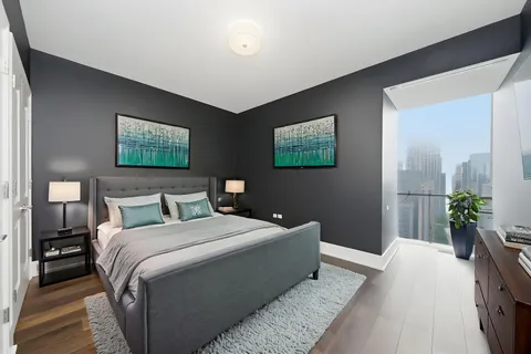 a bedroom with a bed and a potted plant