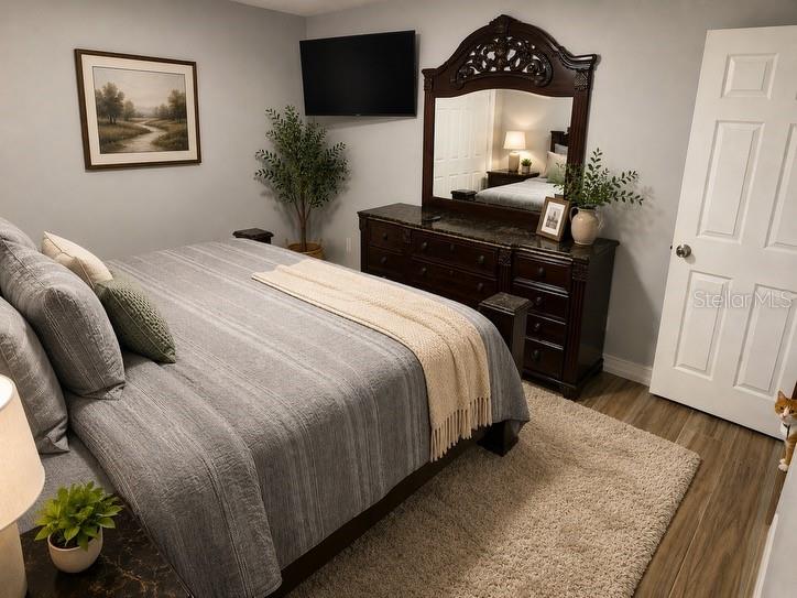 1623 Wavecrest Street Merritt Island, FL 32952 - Photo 19 of 26 a bedroom with a bed and a mirror on dresser
