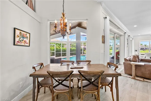 a view of a dining room with furniture wooden floor and a chandelier