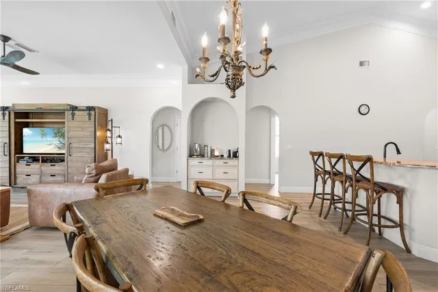 a view of a dining room with furniture and a chandelier