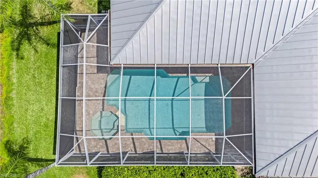 an aerial view of a house with a lake view