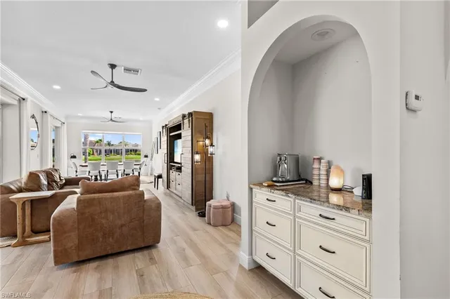 a living room with furniture windows and a flat screen tv