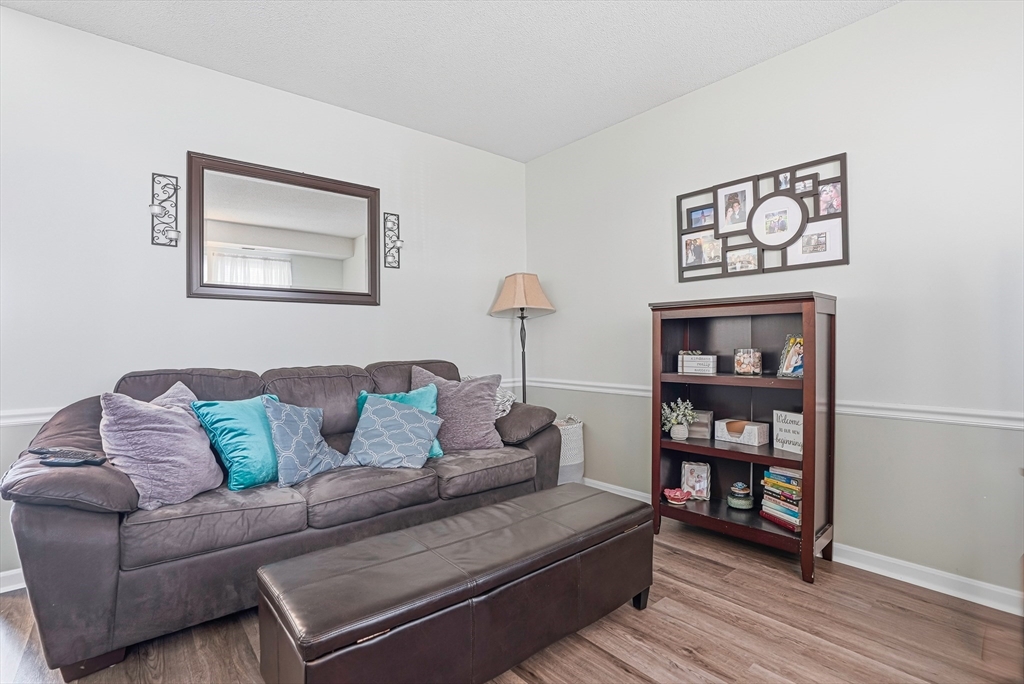96 Century Way, Unit 96 Gardner, MA 01440 - Photo 12 of 41 a living room with furniture and a wooden floor