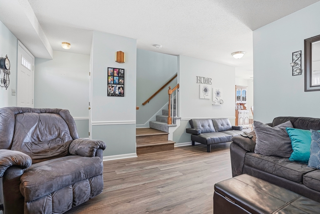 96 Century Way, Unit 96 Gardner, MA 01440 - Photo 13 of 41 a living room with furniture and stairs