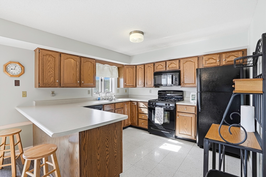 96 Century Way, Unit 96 Gardner, MA 01440 - Photo 18 of 41 a kitchen with stainless steel appliances granite countertop a refrigerator and a stove top oven
