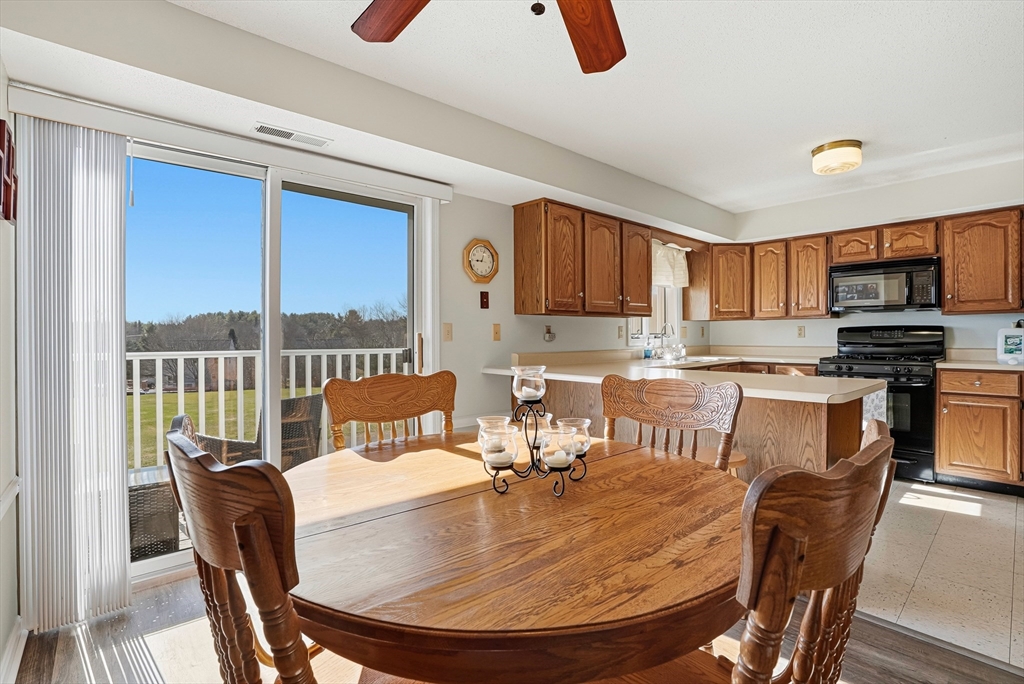 96 Century Way, Unit 96 Gardner, MA 01440 - Photo 27 of 41 a dining room with furniture and a view of kitchen