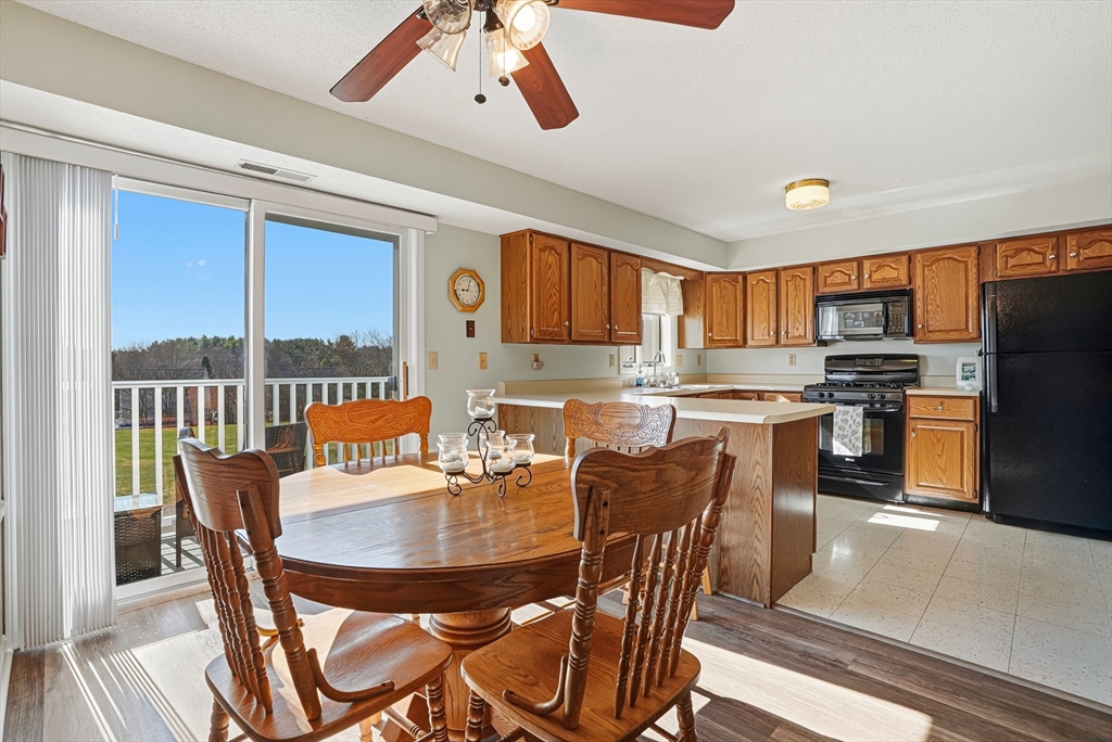 96 Century Way, Unit 96 Gardner, MA 01440 - Photo 28 of 41 a dining room with furniture and a kitchen view
