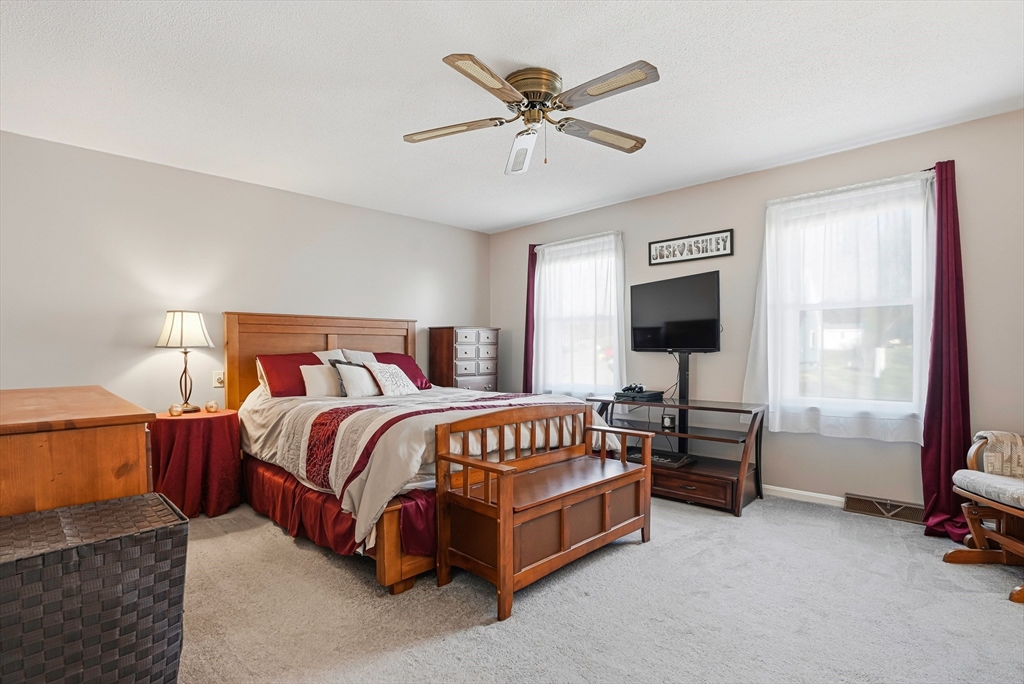 96 Century Way, Unit 96 Gardner, MA 01440 - Photo 32 of 41 a bedroom with a bed and a chandelier