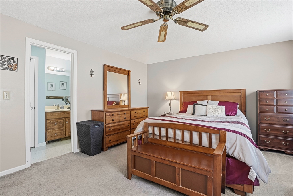 96 Century Way, Unit 96 Gardner, MA 01440 - Photo 33 of 41 a bedroom with a bed and a chandelier