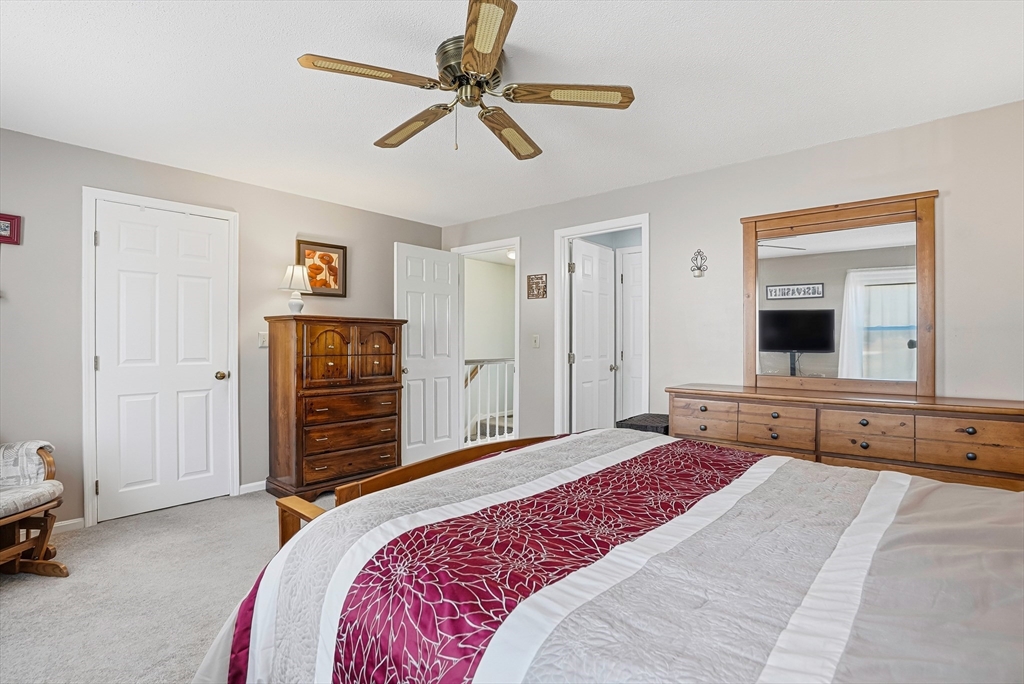 96 Century Way, Unit 96 Gardner, MA 01440 - Photo 34 of 41 a bedroom with a bed and a chandelier