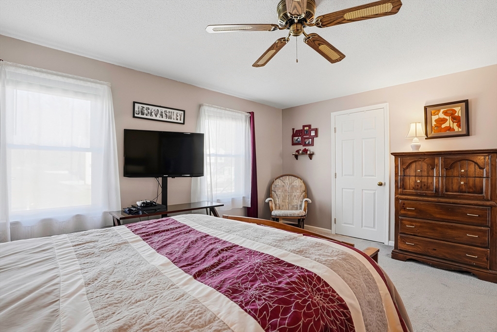 96 Century Way, Unit 96 Gardner, MA 01440 - Photo 35 of 41 a bedroom with a bed and a flat screen tv
