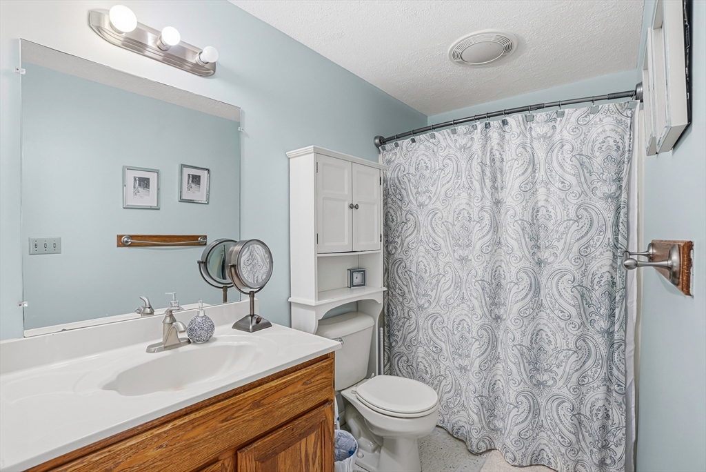 96 Century Way, Unit 96 Gardner, MA 01440 - Photo 36 of 41 a bathroom with a toilet sink and mirror