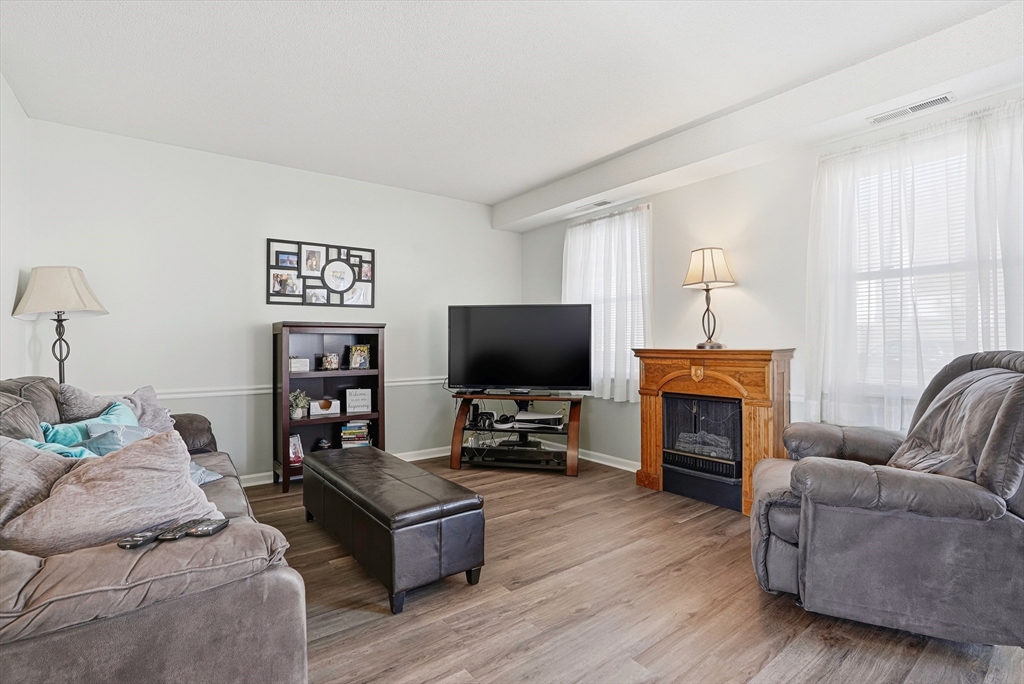 96 Century Way, Unit 96 Gardner, MA 01440 - Photo 8 of 41 a living room with furniture and a flat screen tv
