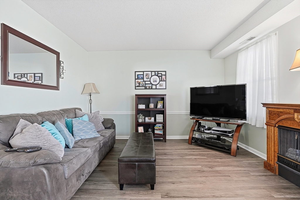 96 Century Way, Unit 96 Gardner, MA 01440 - Photo 9 of 41 a living room with furniture and a flat screen tv