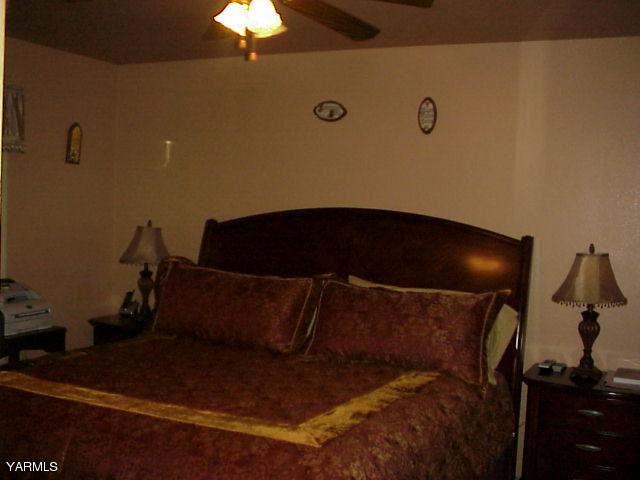 887 Ismo Loop Sunnyside, WA 98944 - Photo 4 of 7 a bed sitting in a bedroom next to a lamp