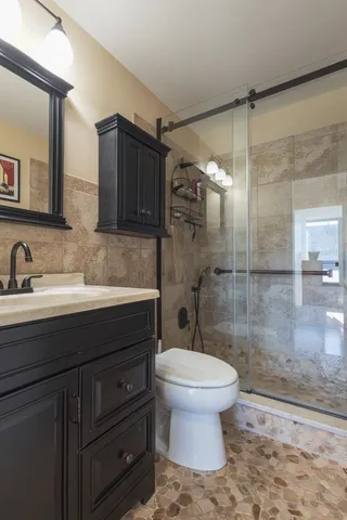a bathroom with a sink toilet and shower