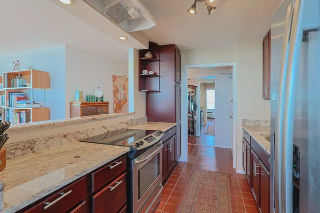a spacious bathroom with a granite countertop sink and a mirror