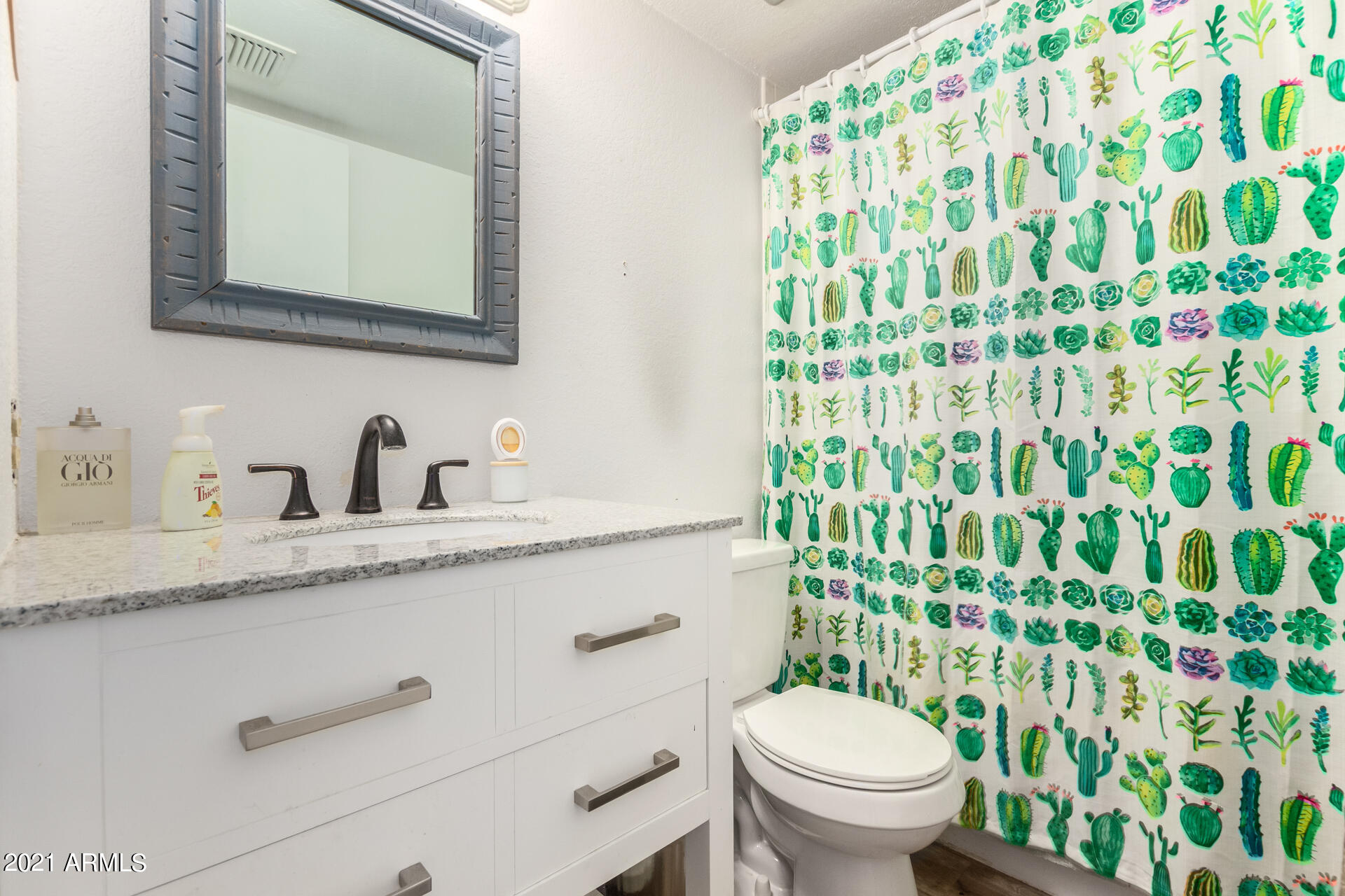 2056 South Rural Road, Unit C Tempe, AZ 85282 - Photo 21 of 25 a bathroom with a granite countertop sink a toilet and a mirror