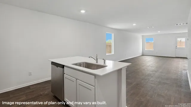 a kitchen with a sink and cabinets