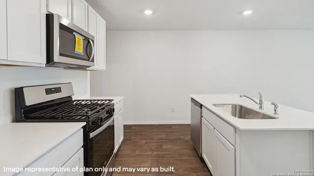 a kitchen with stainless steel appliances granite countertop a sink and cabinets