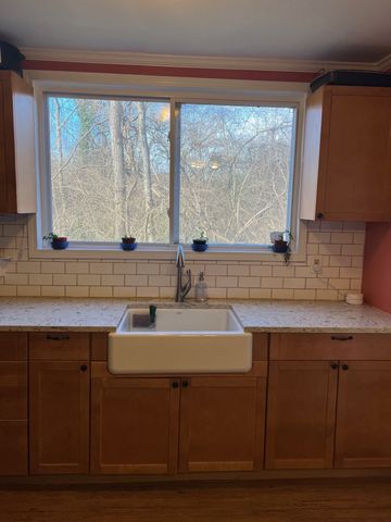 a kitchen with a sink and large window