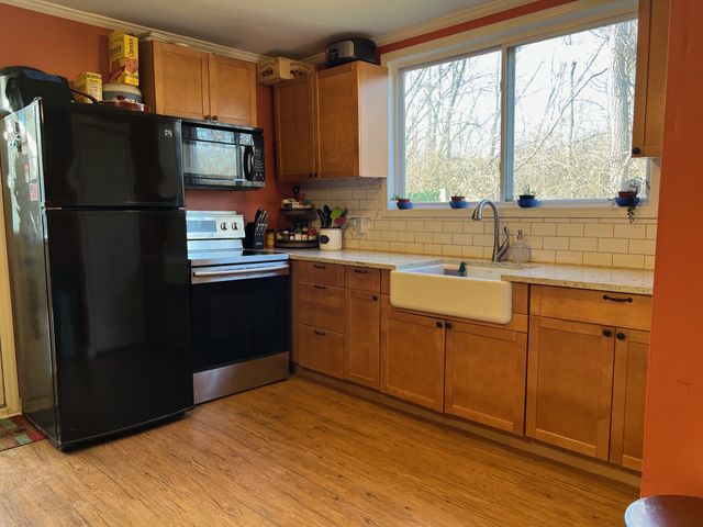 a kitchen with a refrigerator stove and sink