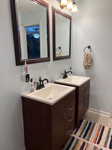 a bathroom with a double vanity sink and mirror