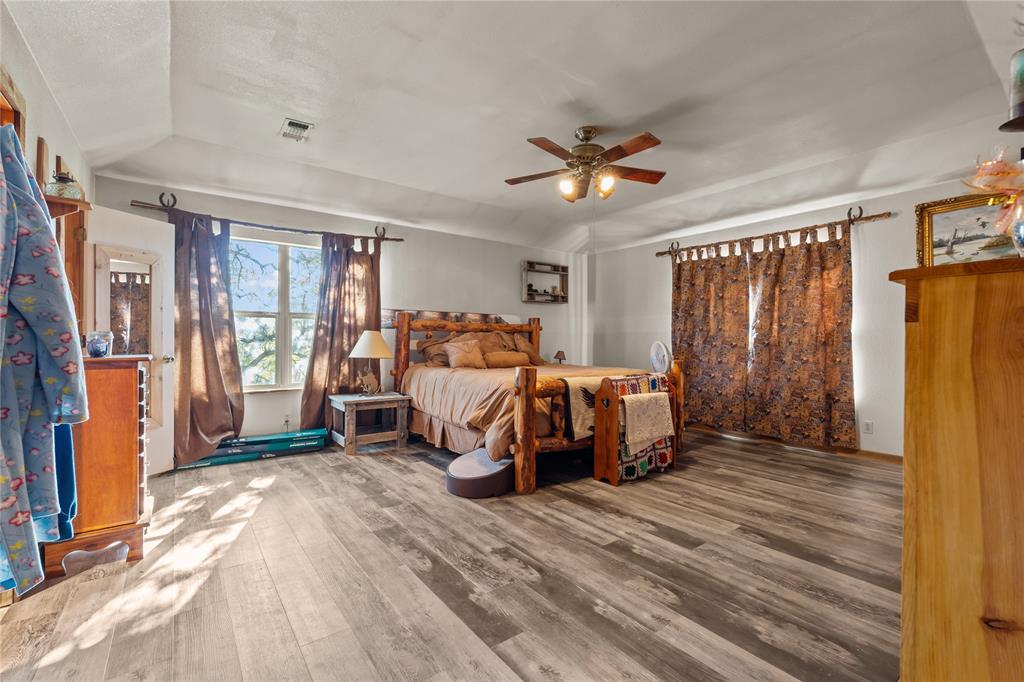 262 North Cheyenne Springtown, TX 76082 - Photo 21 of 35 Bedroom featuring wood finished floors, ceiling fan, and vaulted ceiling