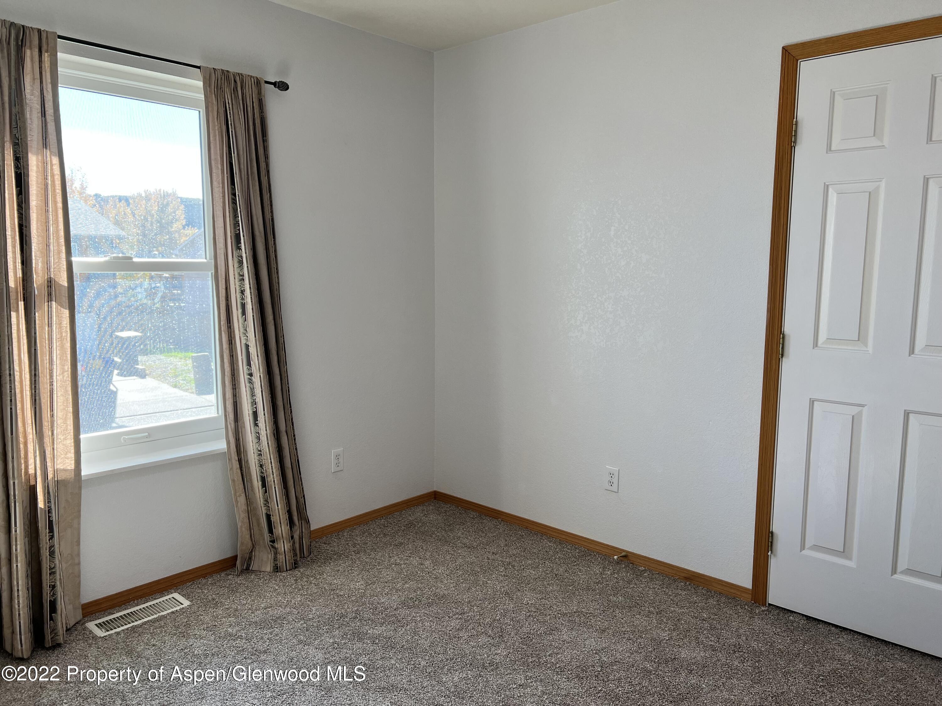 2447 Meadow Circle Rifle, CO 81650 - Photo 12 of 36 an empty room with windows