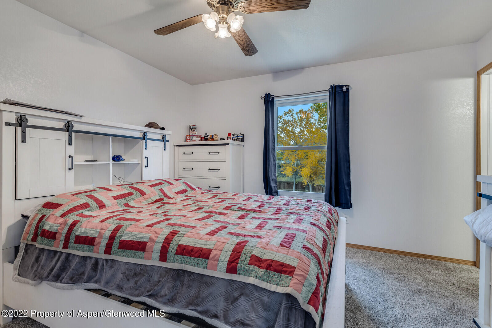 2447 Meadow Circle Rifle, CO 81650 - Photo 14 of 36 a bedroom with a bed and a window