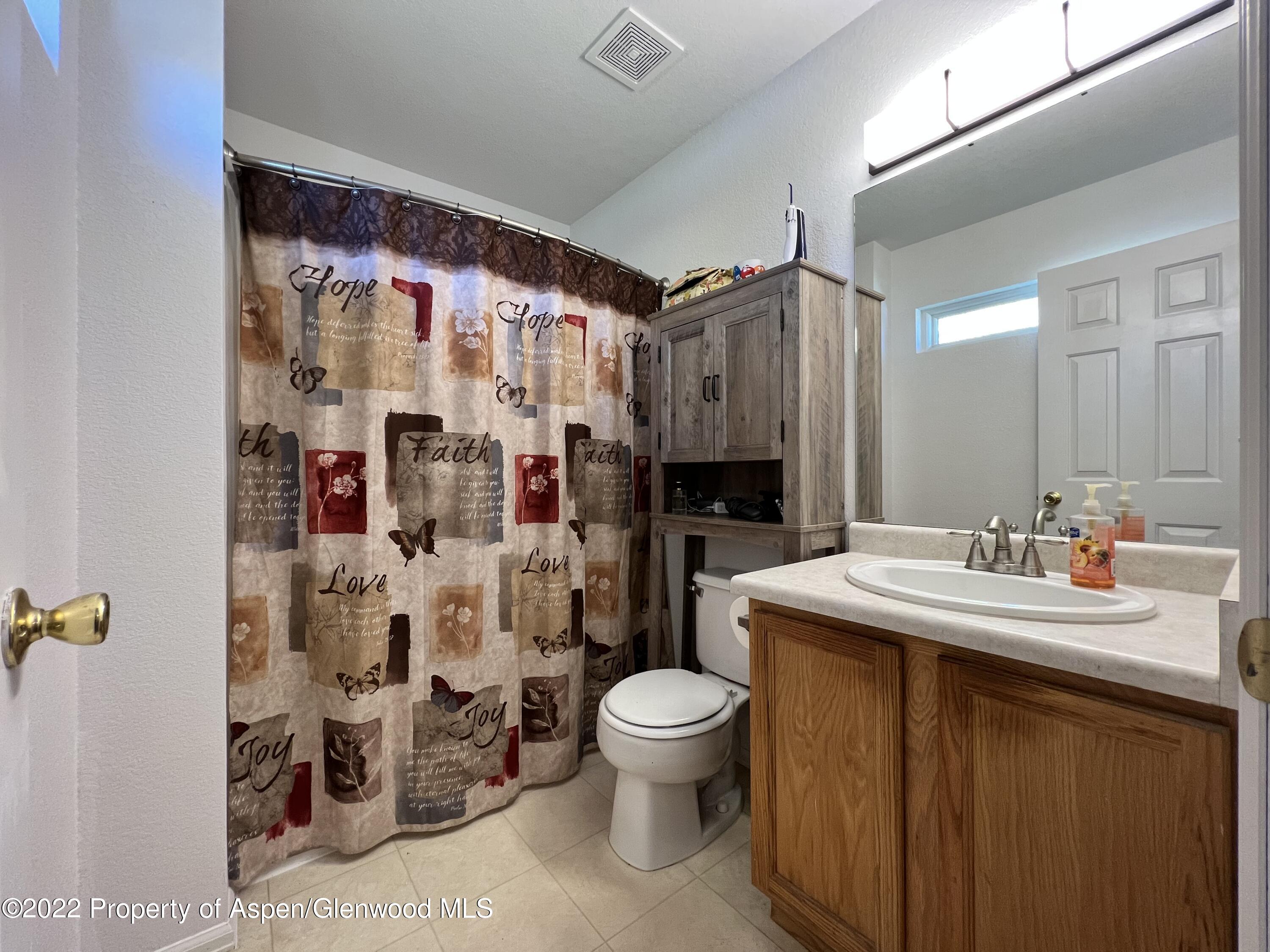 2447 Meadow Circle Rifle, CO 81650 - Photo 17 of 36 a bathroom with a sink toilet and shower