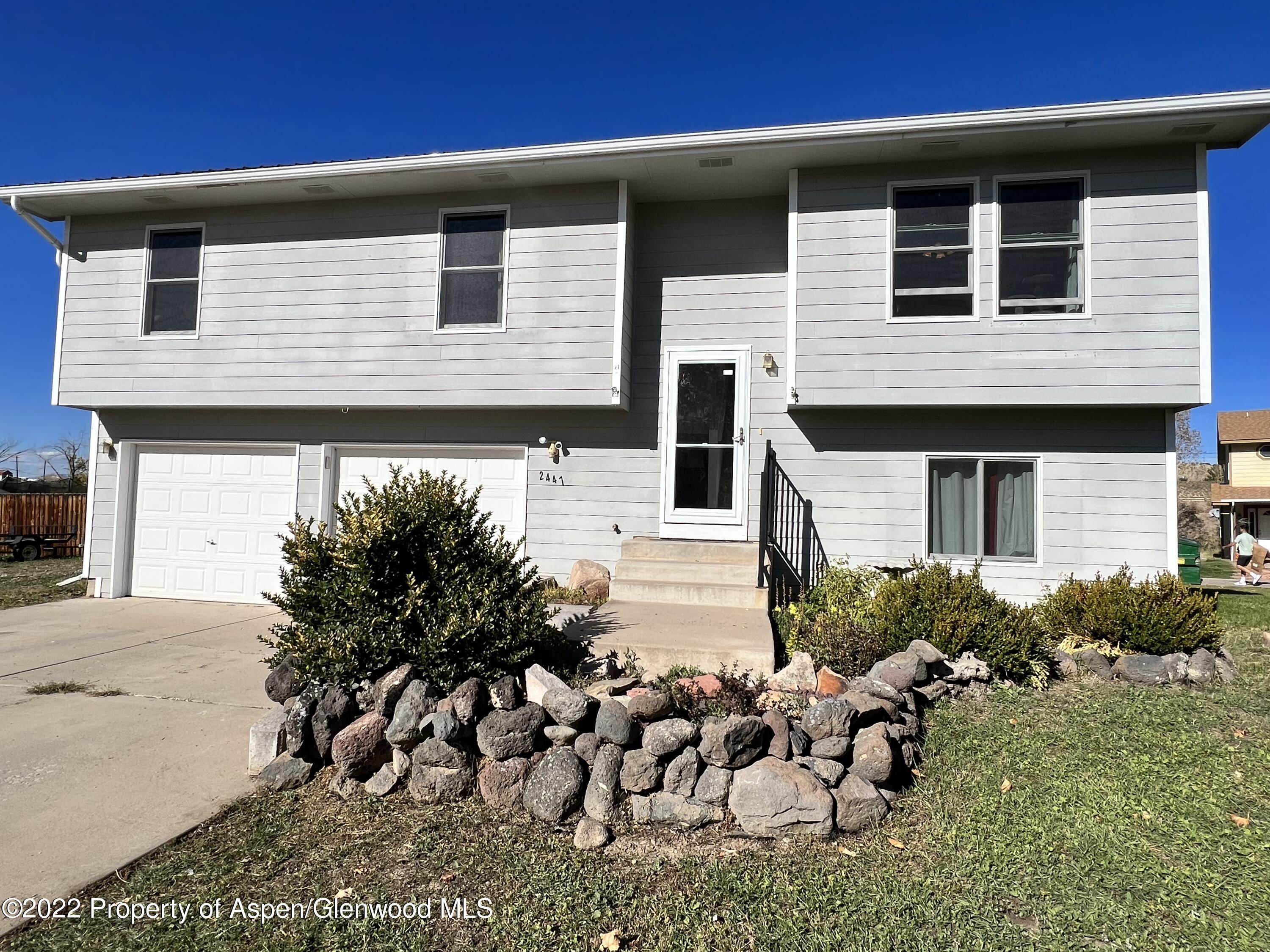 2447 Meadow Circle Rifle, CO 81650 - Photo 2 of 36 a front view of a house with garden