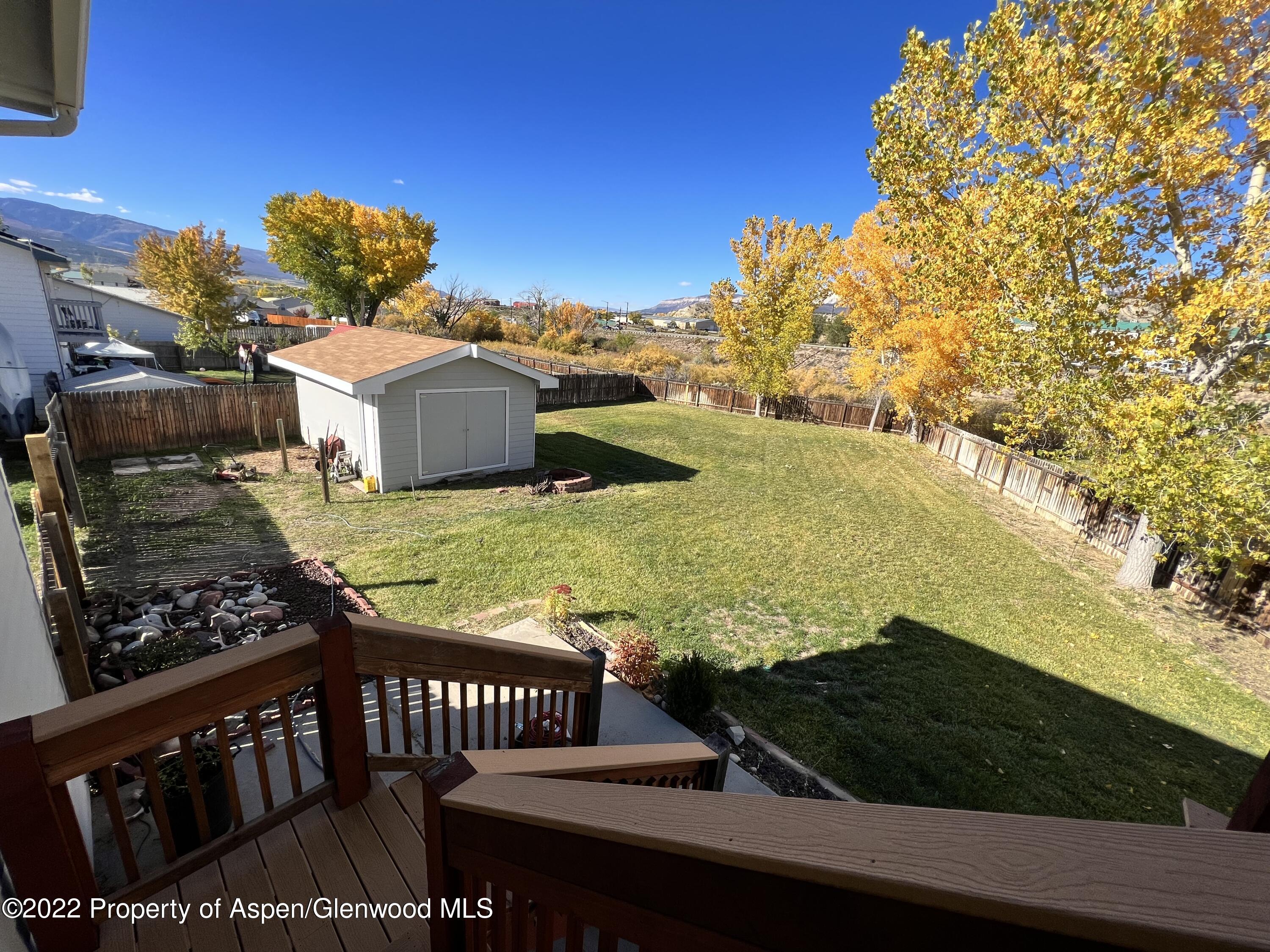 2447 Meadow Circle Rifle, CO 81650 - Photo 25 of 36 a view of a back yard of the house and front view of a house