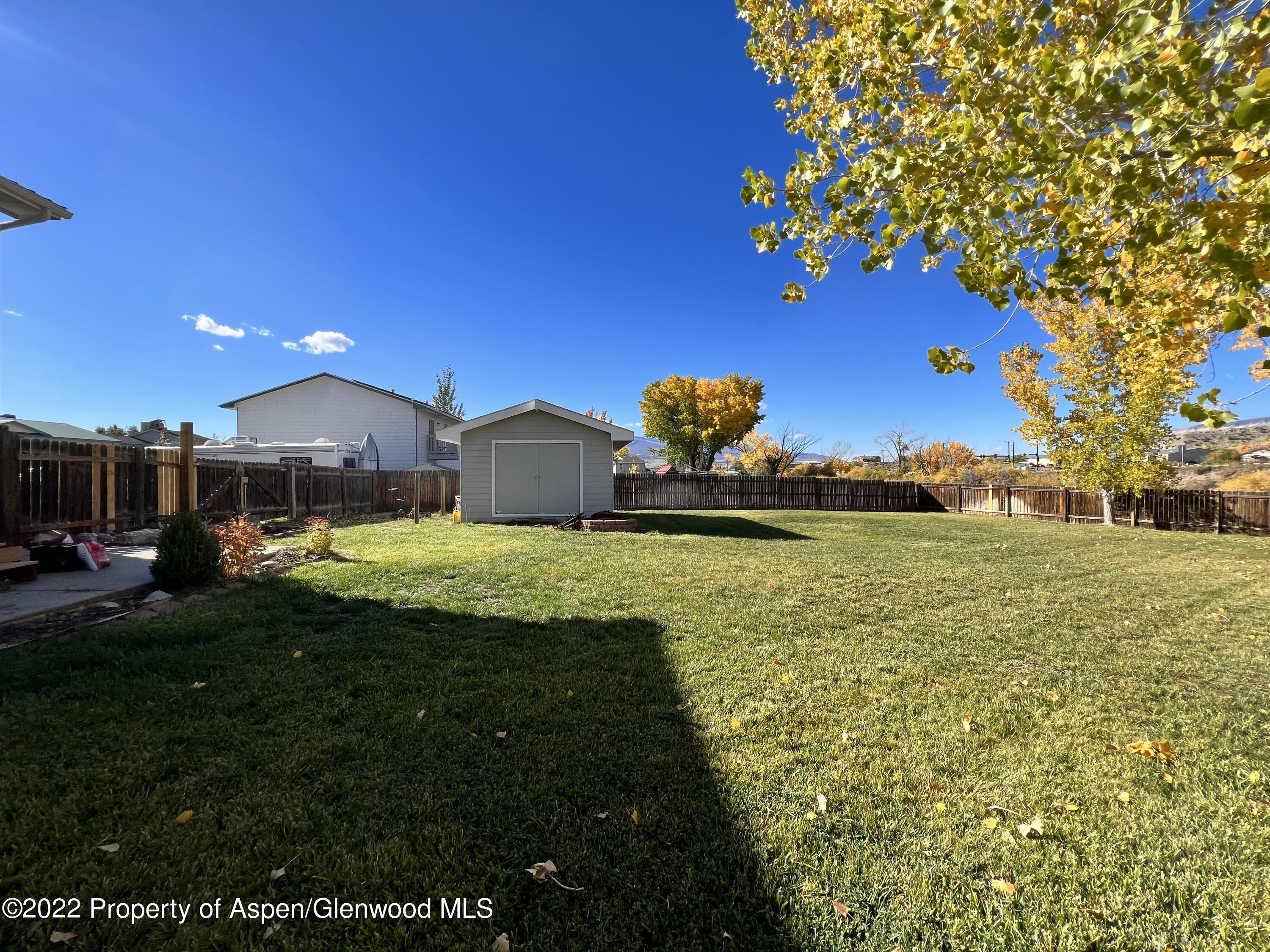 2447 Meadow Circle Rifle, CO 81650 - Photo 26 of 36 a front view of a house with garden