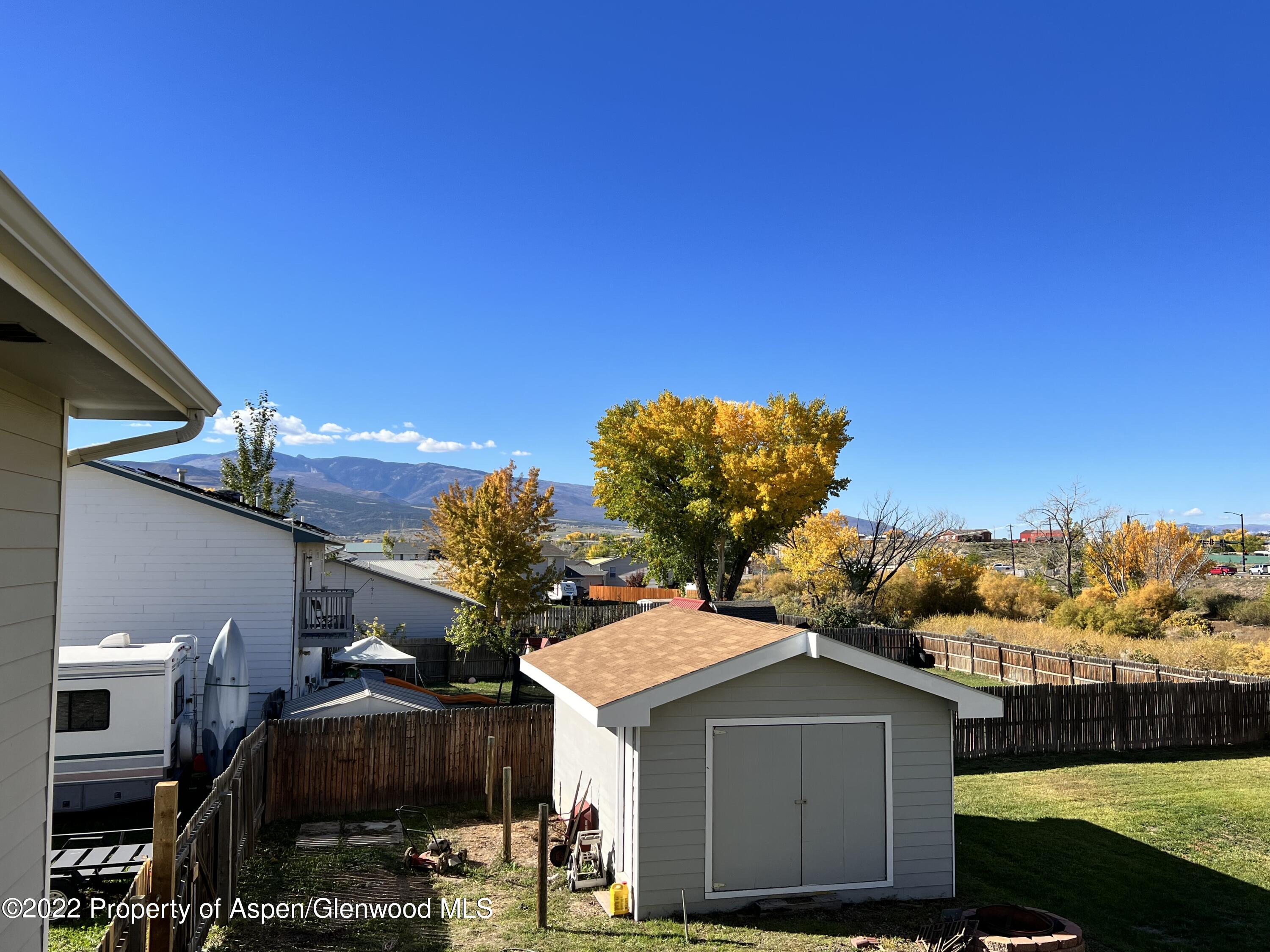 2447 Meadow Circle Rifle, CO 81650 - Photo 27 of 36 a front view of a house with a yard