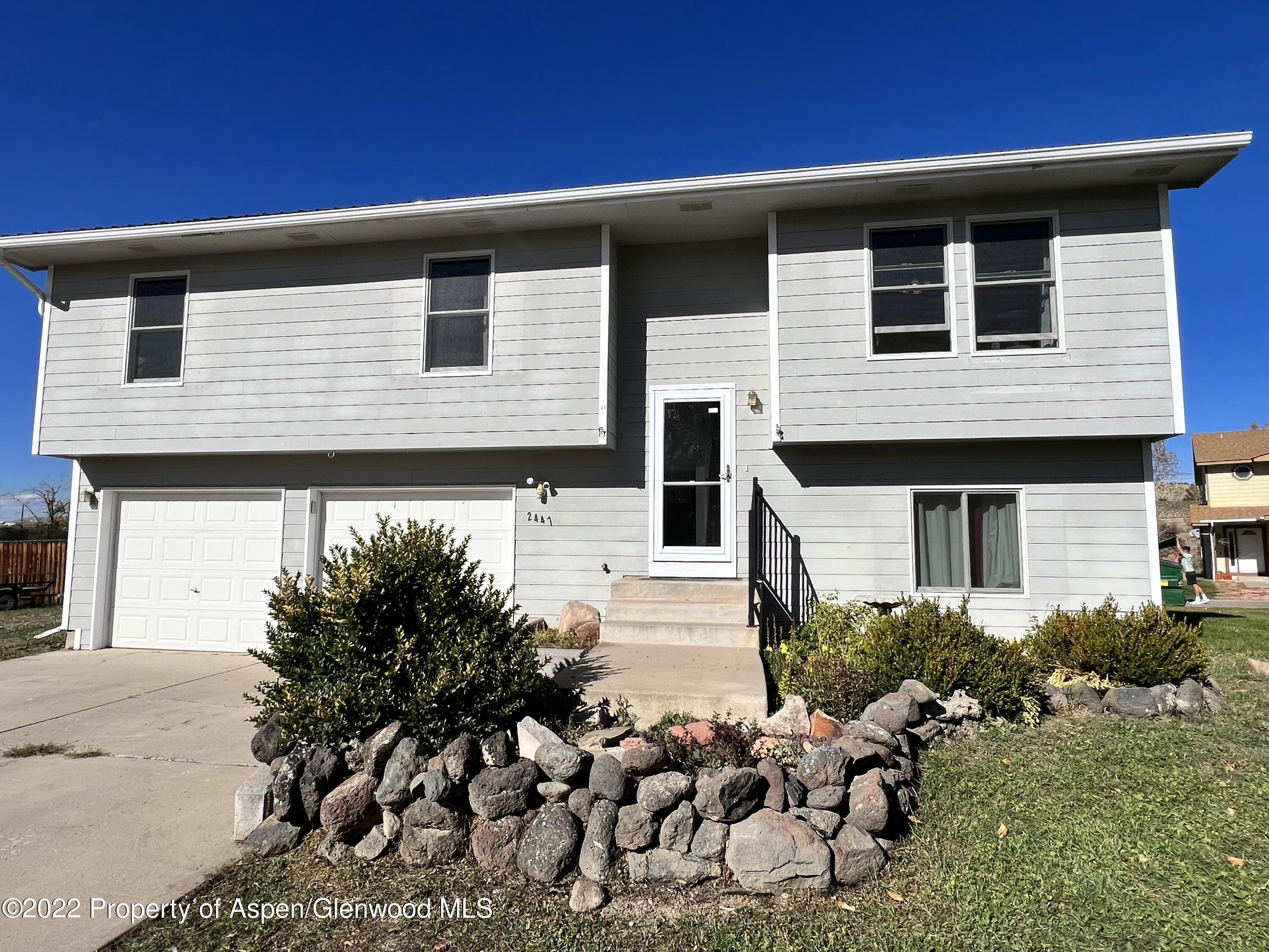 2447 Meadow Circle Rifle, CO 81650 - Photo 29 of 36 a front view of a house with a yard