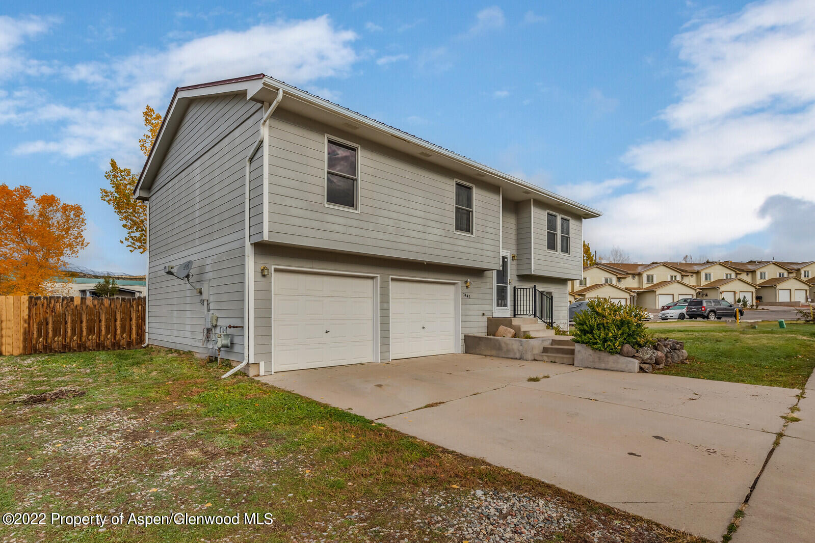 2447 Meadow Circle Rifle, CO 81650 - Photo 34 of 36 a front view of a house with a yard and garage